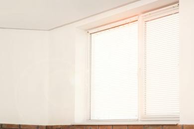 Image of Window with blinds in room on sunny day