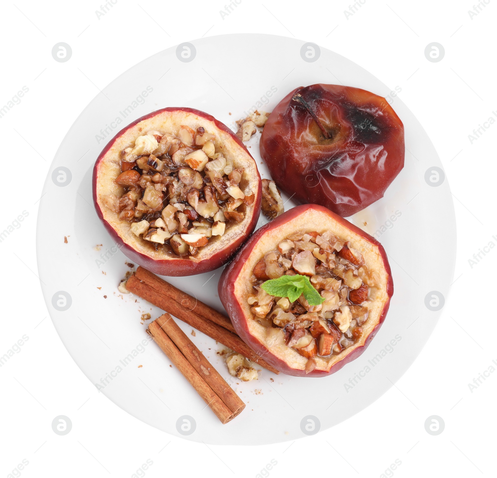 Photo of Tasty baked apples with nuts, honey, cinnamon sticks, top view