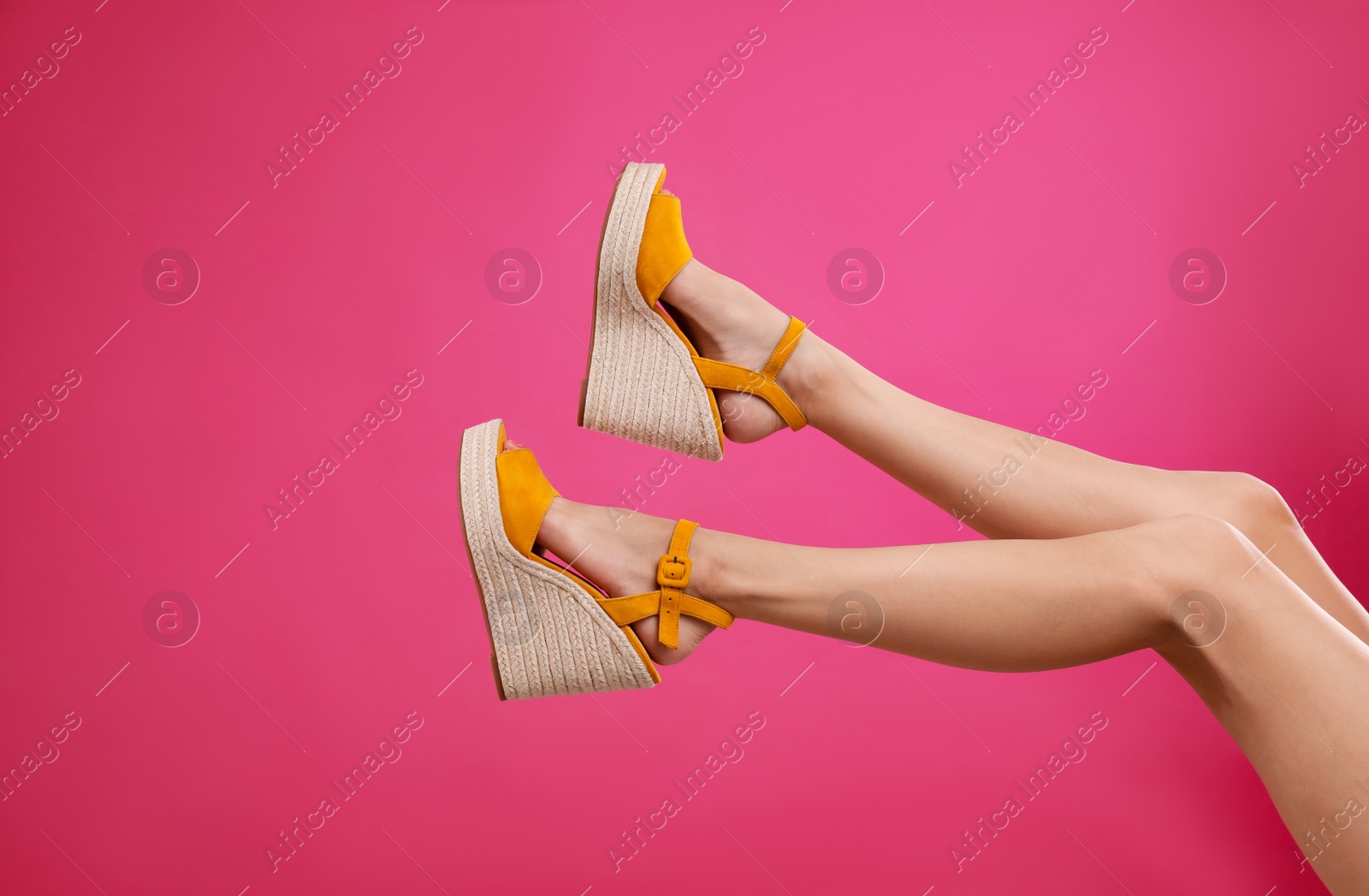 Photo of Woman in stylish shoes on pink background