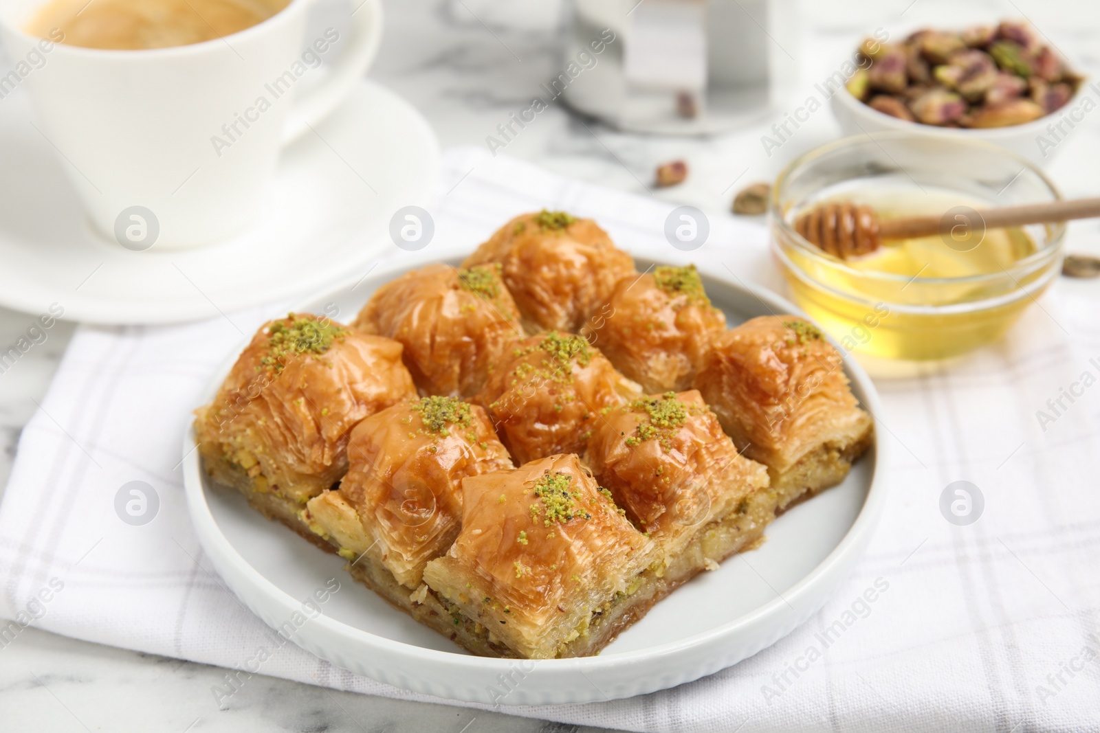 Photo of Delicious sweet baklava on white marble table