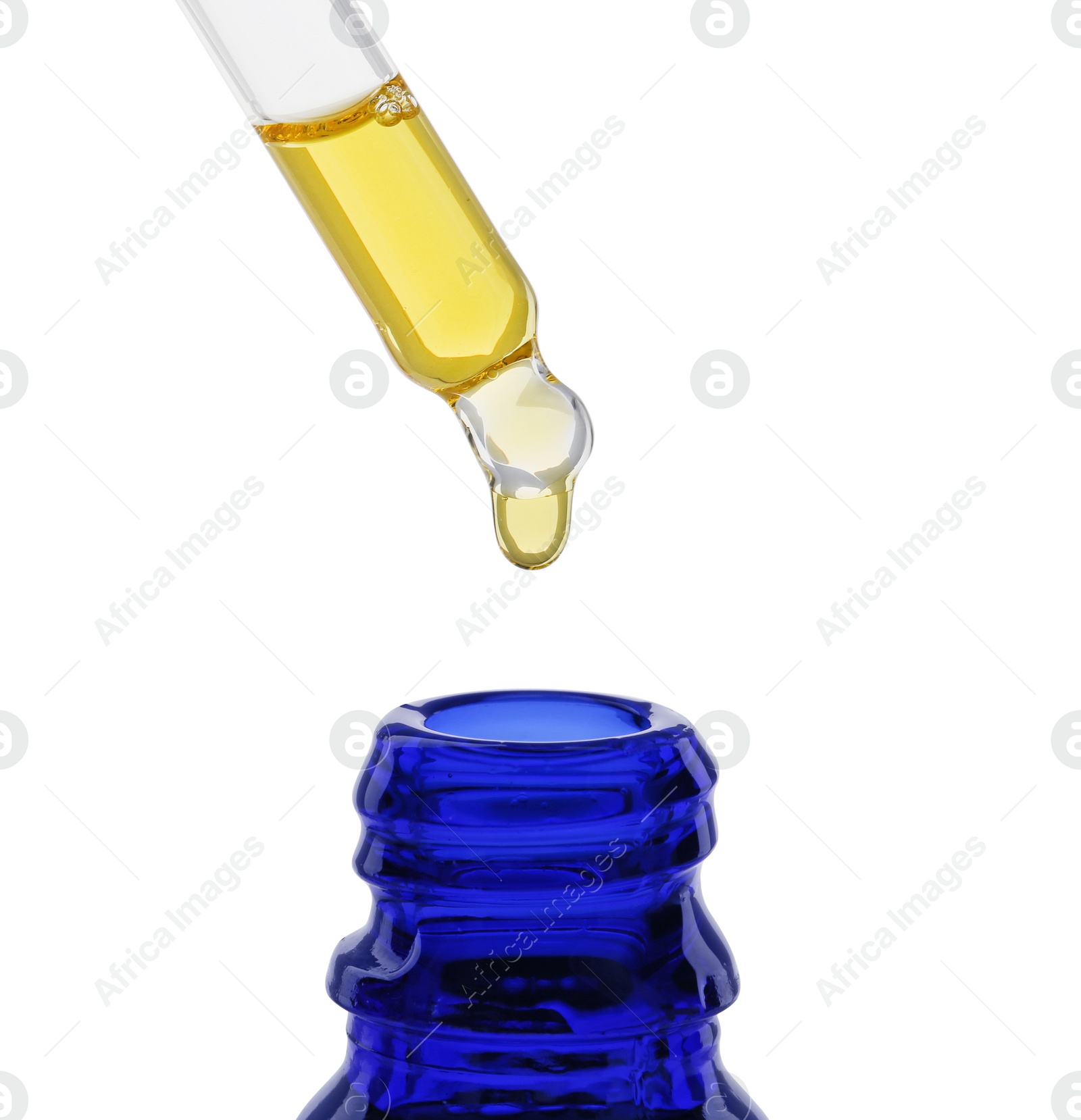 Photo of Dripping tincture from pipette into bottle isolated on white