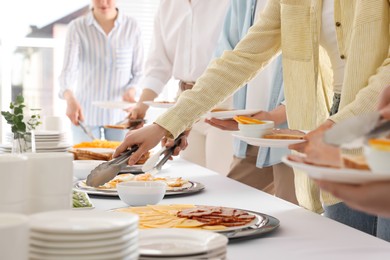 Photo of People taking food during breakfast, closeup. Buffet service