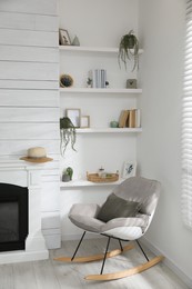 Many shelves with different decor near fireplace in room. Interior design