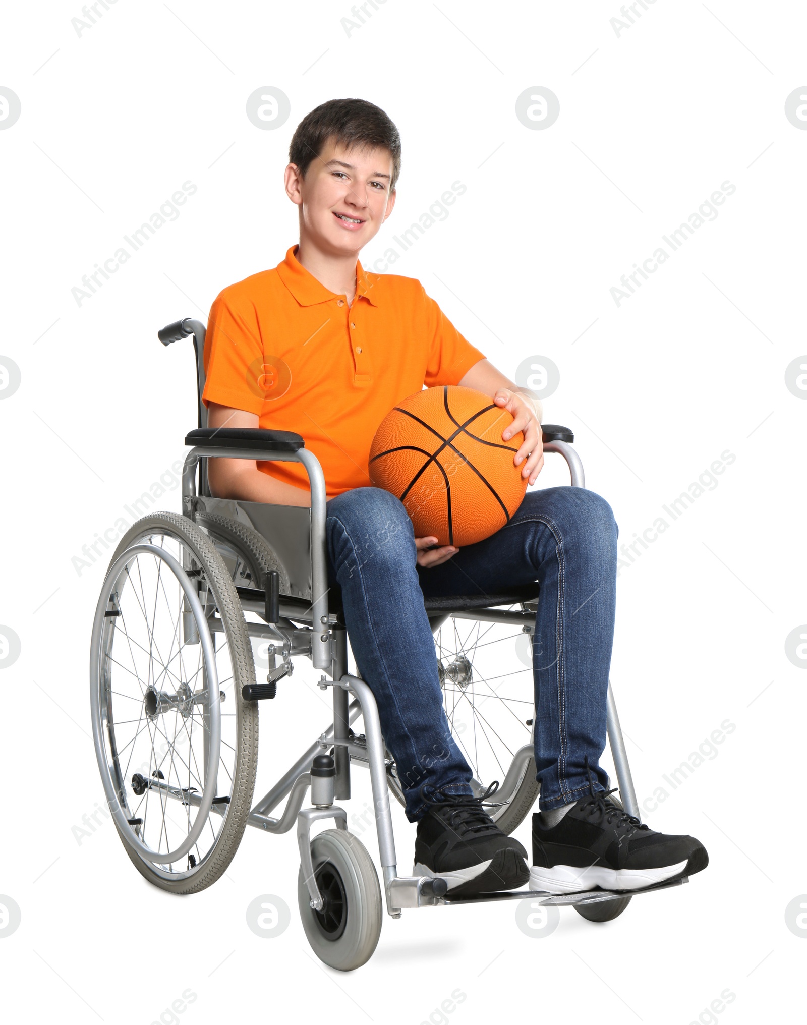 Photo of Disabled teenage boy in wheelchair with basketball ball on white background