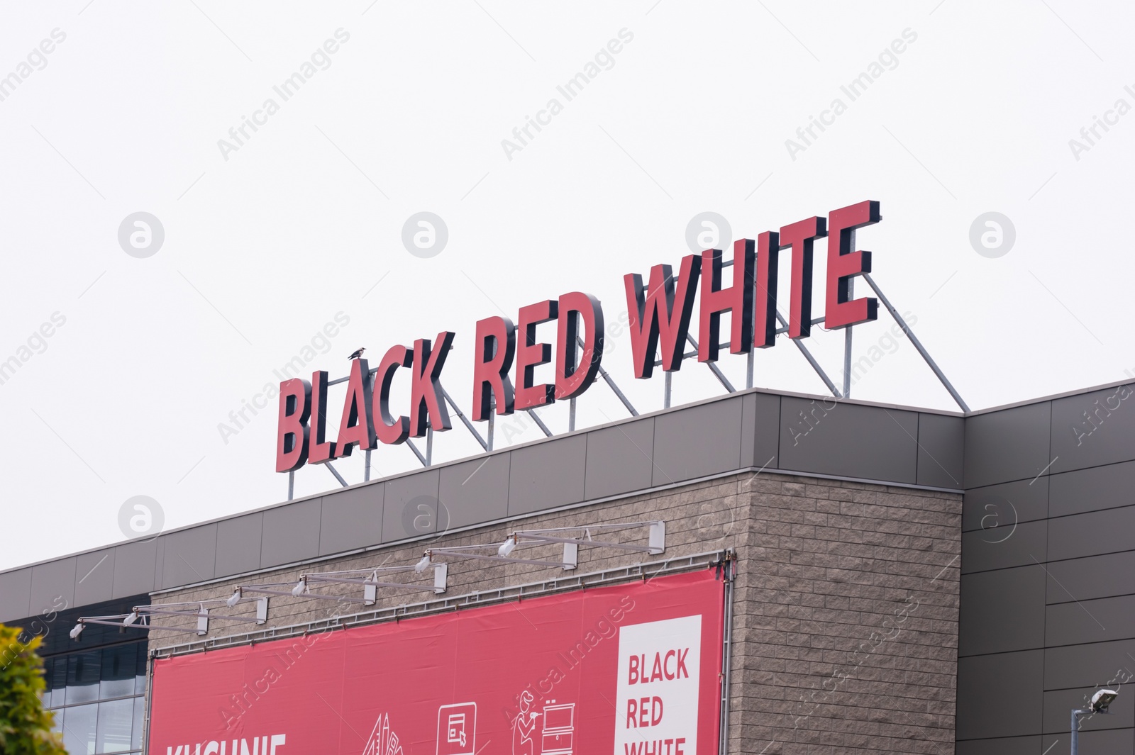 Photo of Warsaw, Poland - September 10, 2022: Building with modern Black Red White logo