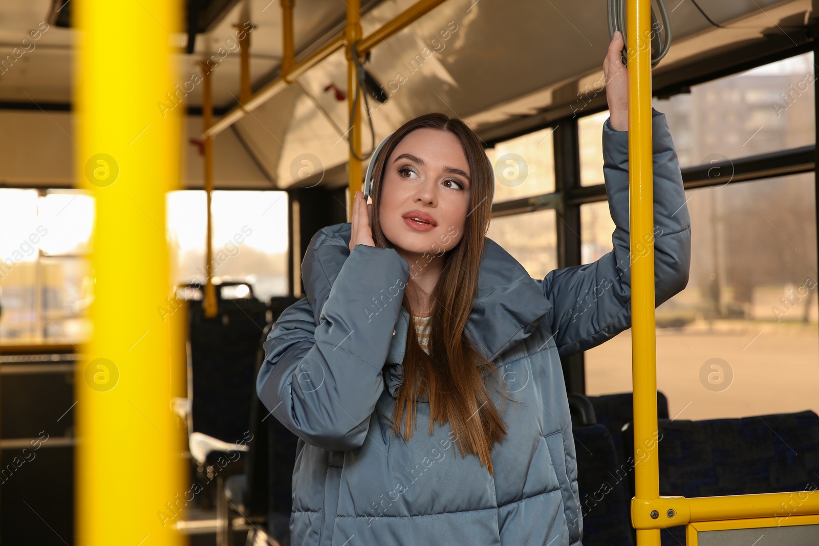 Photo of Woman listening to audiobook in trolley bus