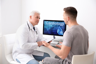 Male doctor working with patient in clinic. Cardiology consultation