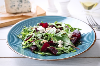 Fresh delicious beet salad on white wooden table