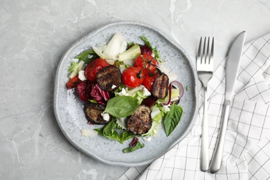 Photo of Delicious salad with roasted eggplant, basil and cheese served on grey marble table, flat lay