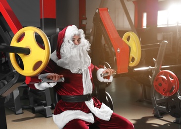 Young Santa Claus training in modern gym