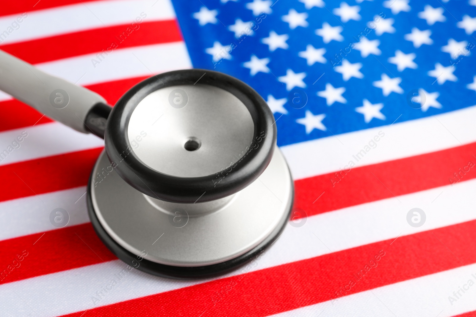Photo of Stethoscope on American flag, closeup. USA medicine and health care concept