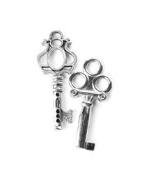 Silver vintage ornate keys on white background, top view