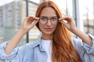 Portrait of beautiful woman in glasses outdoors