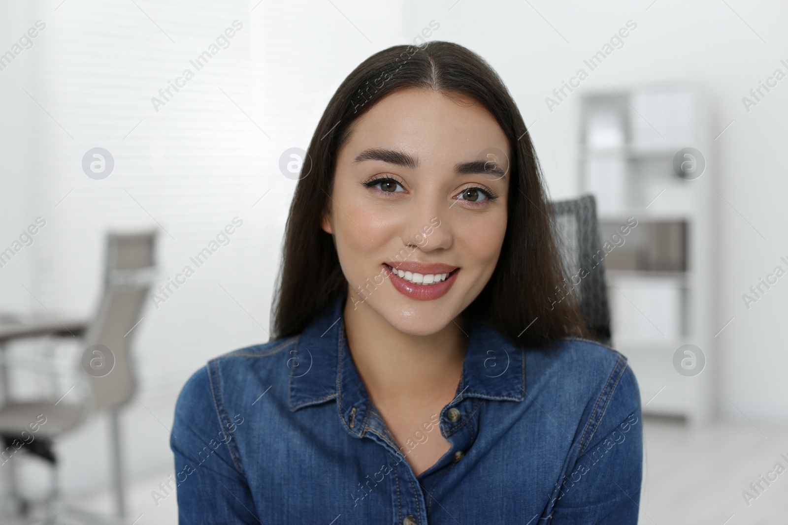 Photo of Portrait of beautiful young woman in office