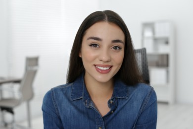 Portrait of beautiful young woman in office