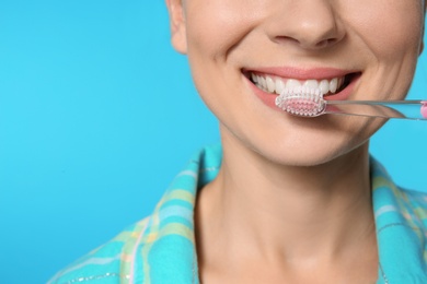 Woman with toothbrush on color background, closeup. Space for text