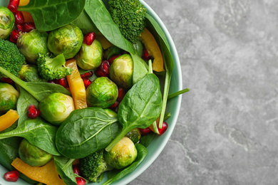 Photo of Tasty salad with Brussels sprouts on grey table, top view