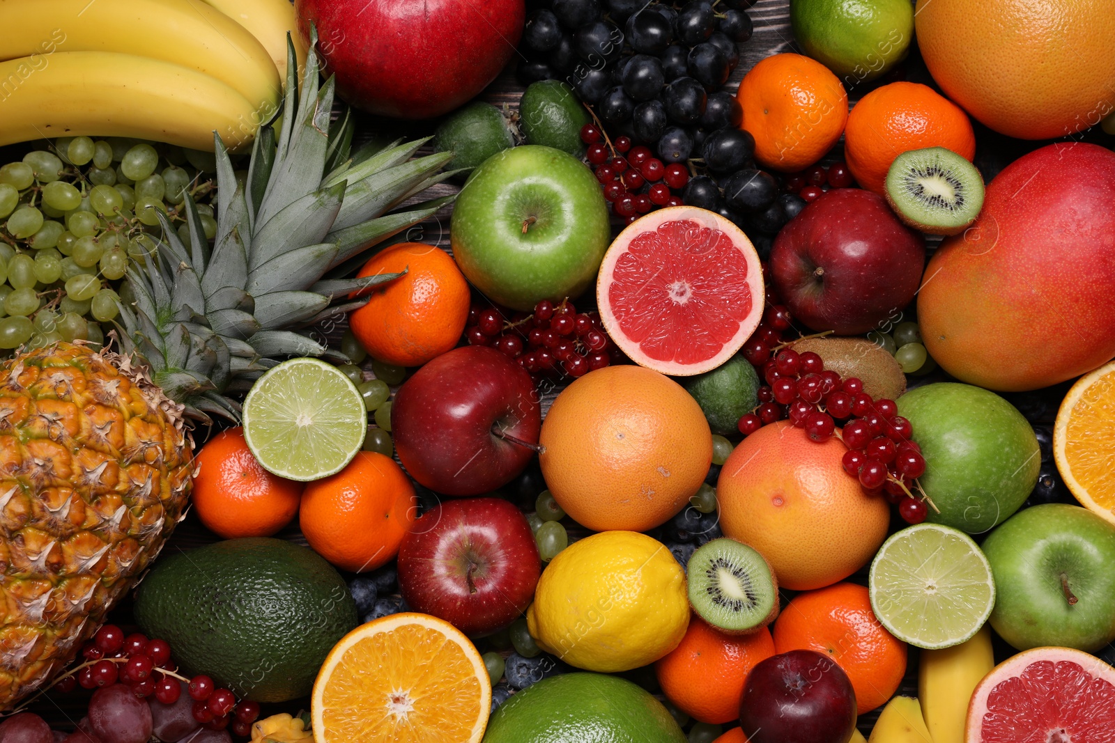 Photo of Different ripe fruits and berries as background, top view