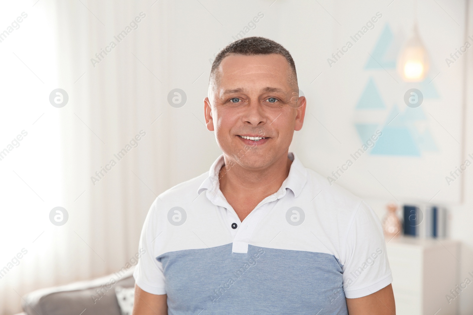 Photo of Portrait of happy mature man at home