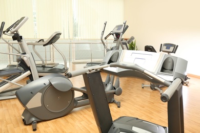 Elliptical trainers and treadmills in gym. Modern sport equipment
