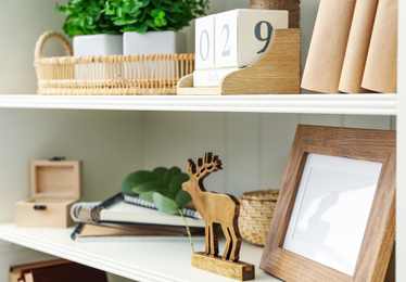 Photo of White shelving unit with different decorative elements