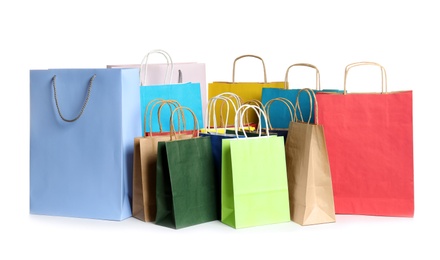 Photo of Colorful paper shopping bags on white background