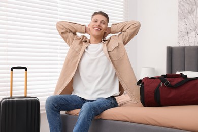 Smiling guest stretching in stylish hotel room