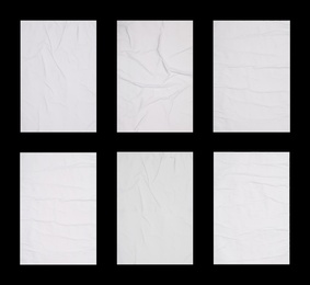 Image of Collection of creased blank posters on black background