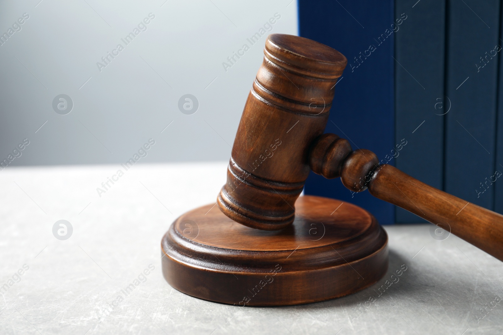 Photo of Wooden gavel and books on table, closeup. Law concept