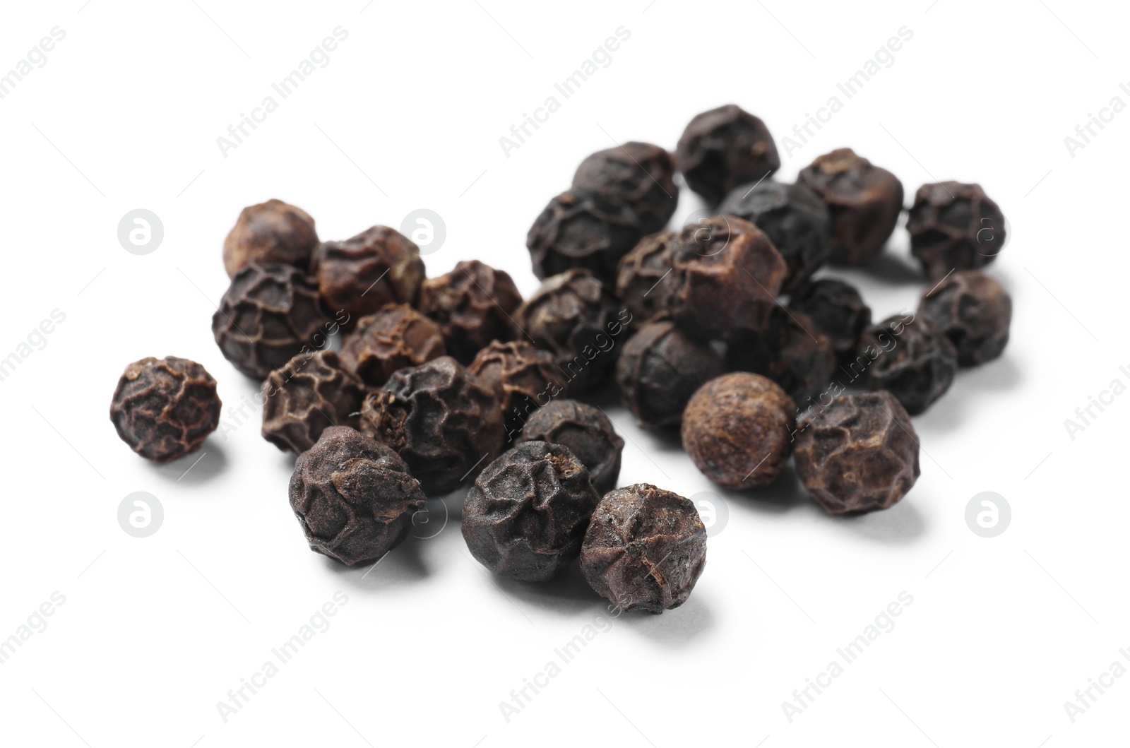 Photo of Aromatic spice. Many black dry peppercorns isolated on white