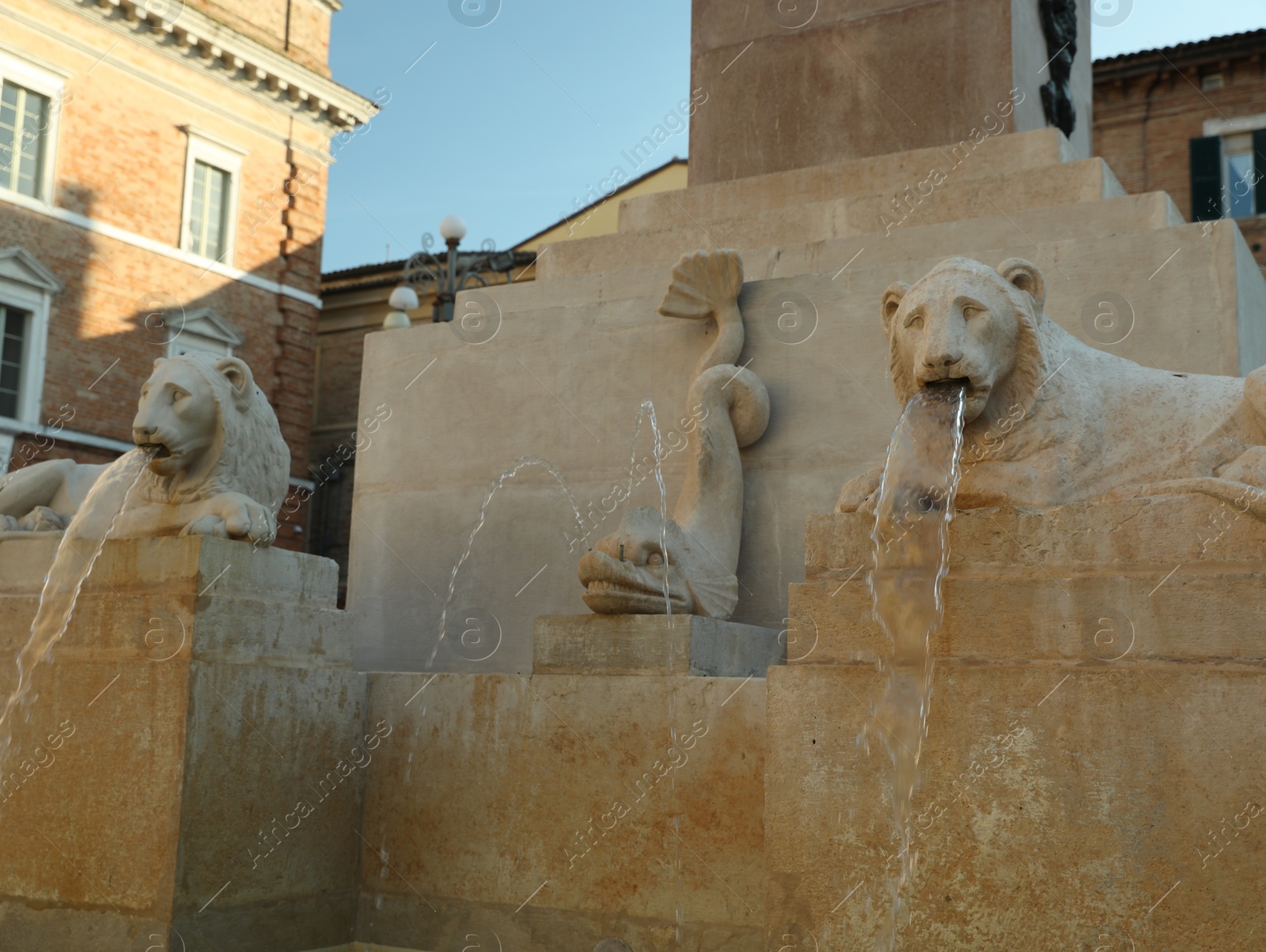 Photo of JESI, ITALY - MAY 17, 2022: Beautiful fountain of stone lions around obelisk on spring day