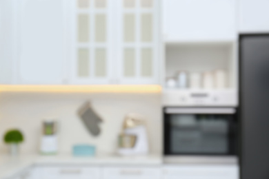 Photo of Blurred view of modern kitchen with appliances