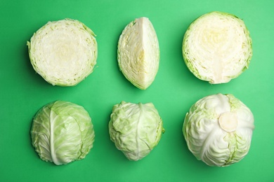 Flat lay composition with ripe cabbages on color background