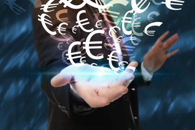 Money exchange concept. Businessman with euro currency symbols on blue background, closeup