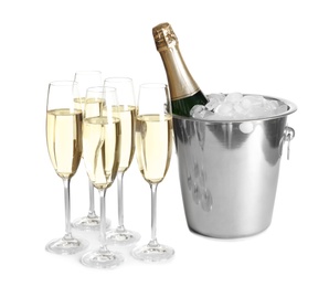 Glasses with champagne and bottle in bucket on white background