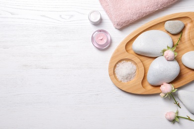 Photo of Flat lay composition with spa stones and space for text on wooden background