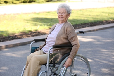 Photo of Senior woman in wheelchair at park on sunny day