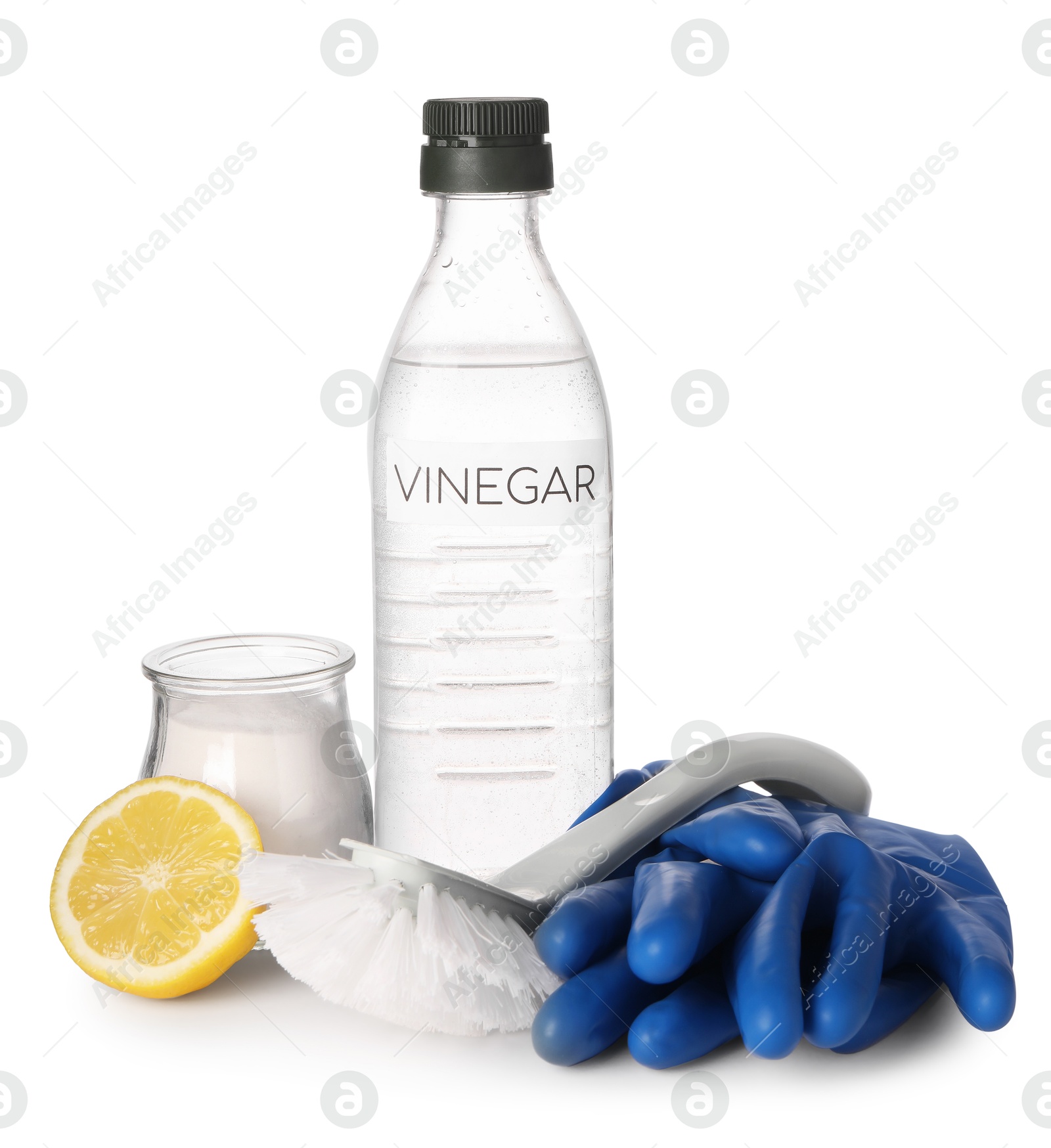 Photo of Eco friendly natural cleaners. Vinegar in bottle, brush, jar of soda, cut lemon and gloves isolated on white