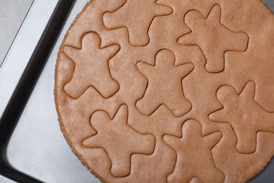 Making homemade gingerbread man cookies in baking dish, top view