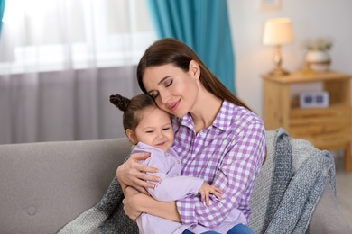 Young mother with little daughter at home