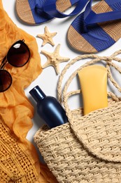 Photo of Flat lay composition with wicker bag and other beach accessories on white background