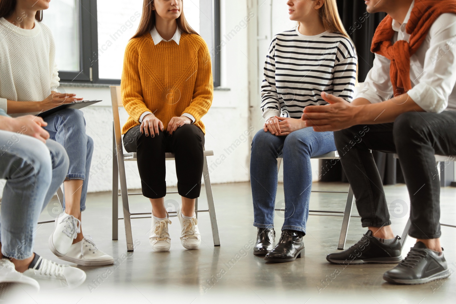 Photo of Psychotherapist working with patients in group therapy session, closeup