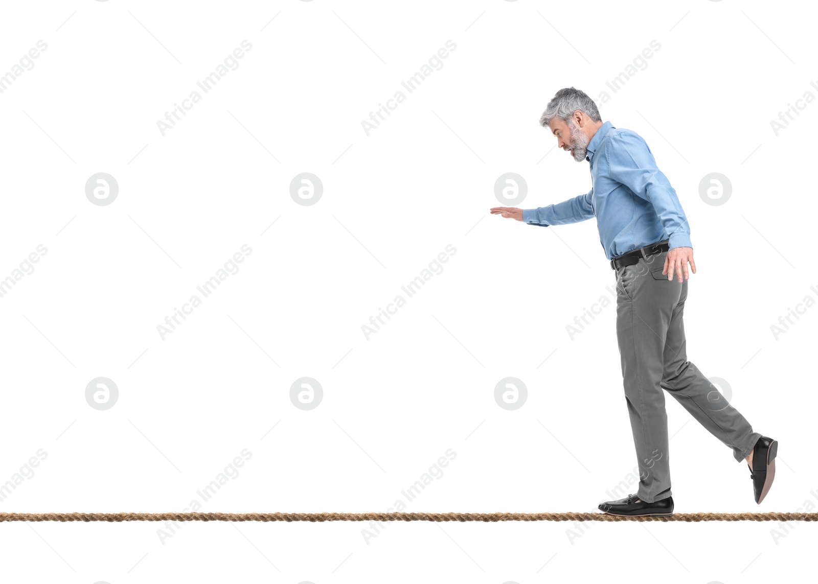 Image of Risks and challenges of owning business. Man balancing on rope against white background