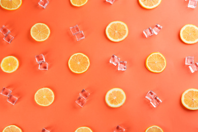 Photo of Lemonade layout with juicy lemon slices and ice cubes on coral background, top view