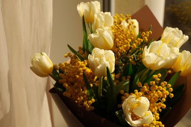 Bouquet of beautiful spring flowers near window, closeup