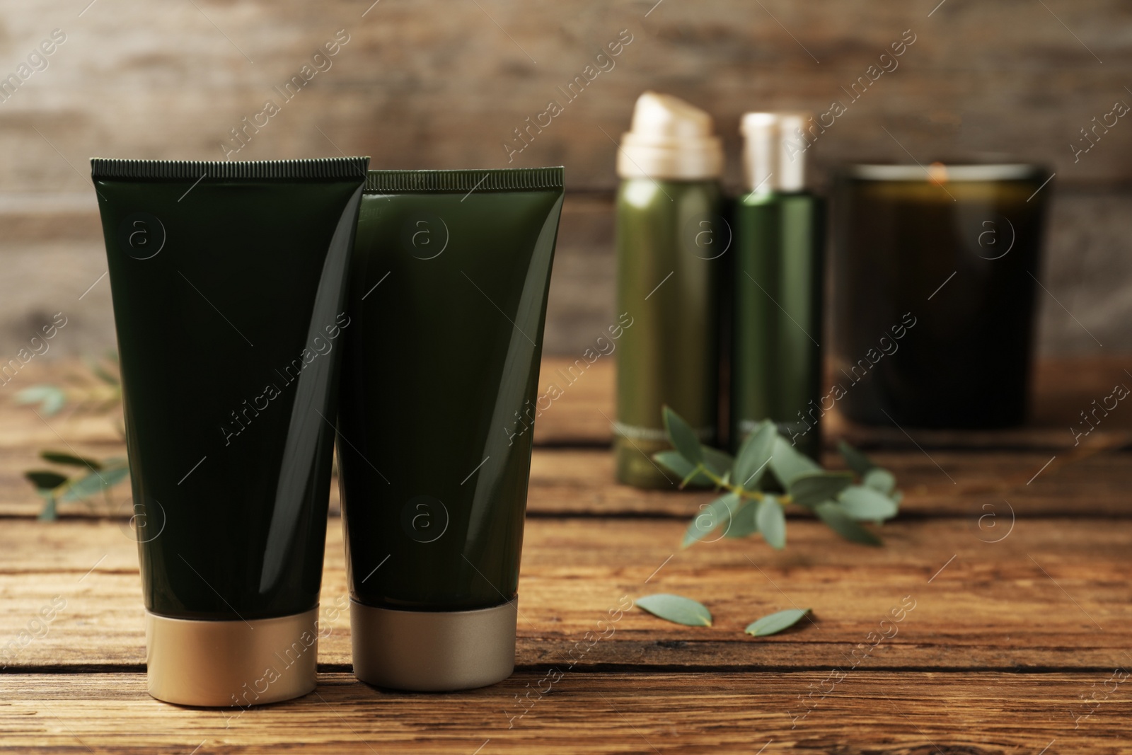 Photo of Different cosmetic products on wooden table, closeup. Space for text