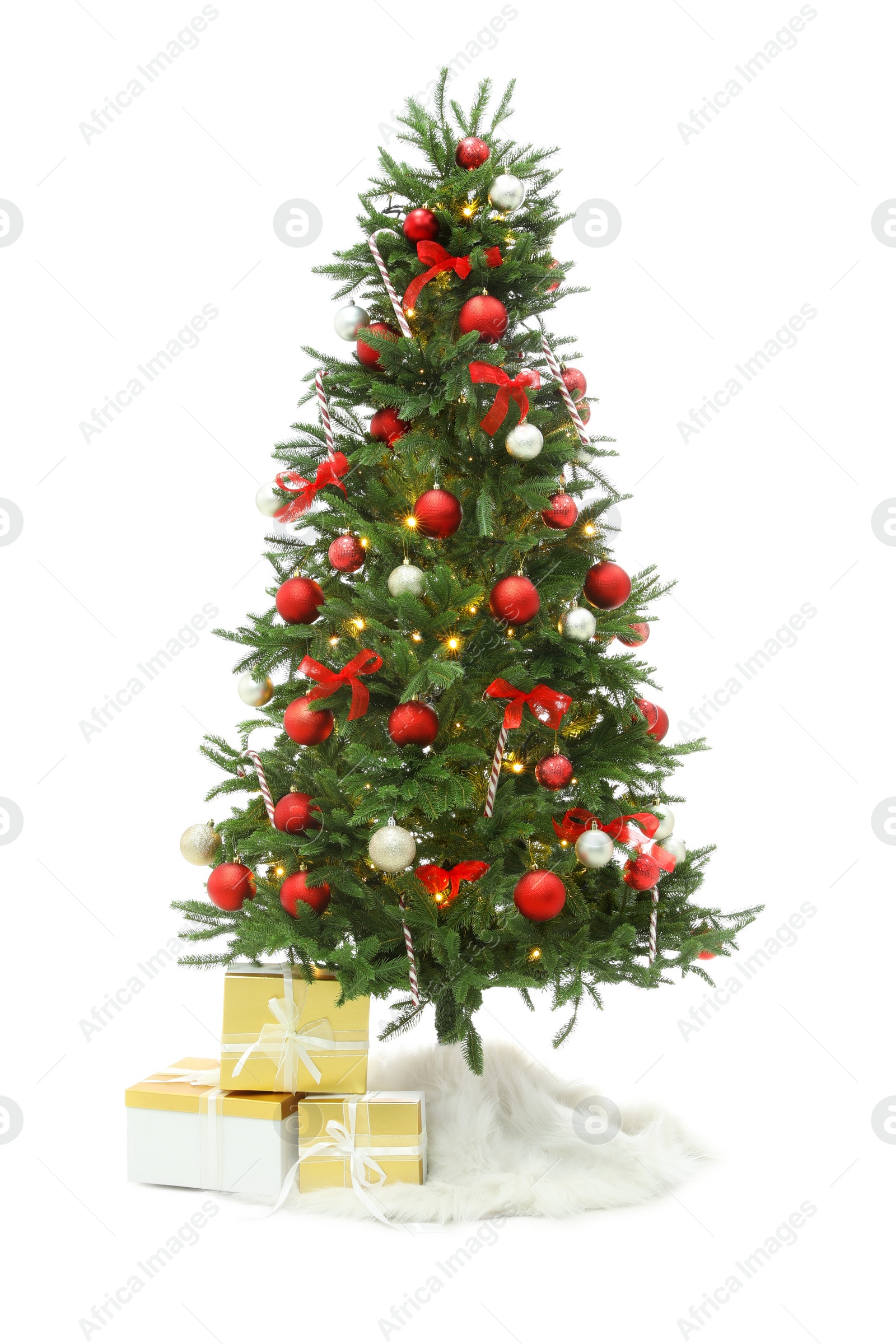 Photo of Beautiful decorated Christmas tree with skirt and gift boxes on white background