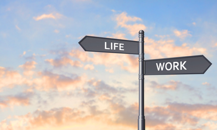 Signpost against beautiful summer sky, space for text. Concept of balance between work and life