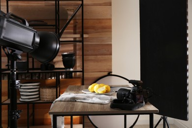 Photo of Professional equipment and many lemons on table in studio. Food photo