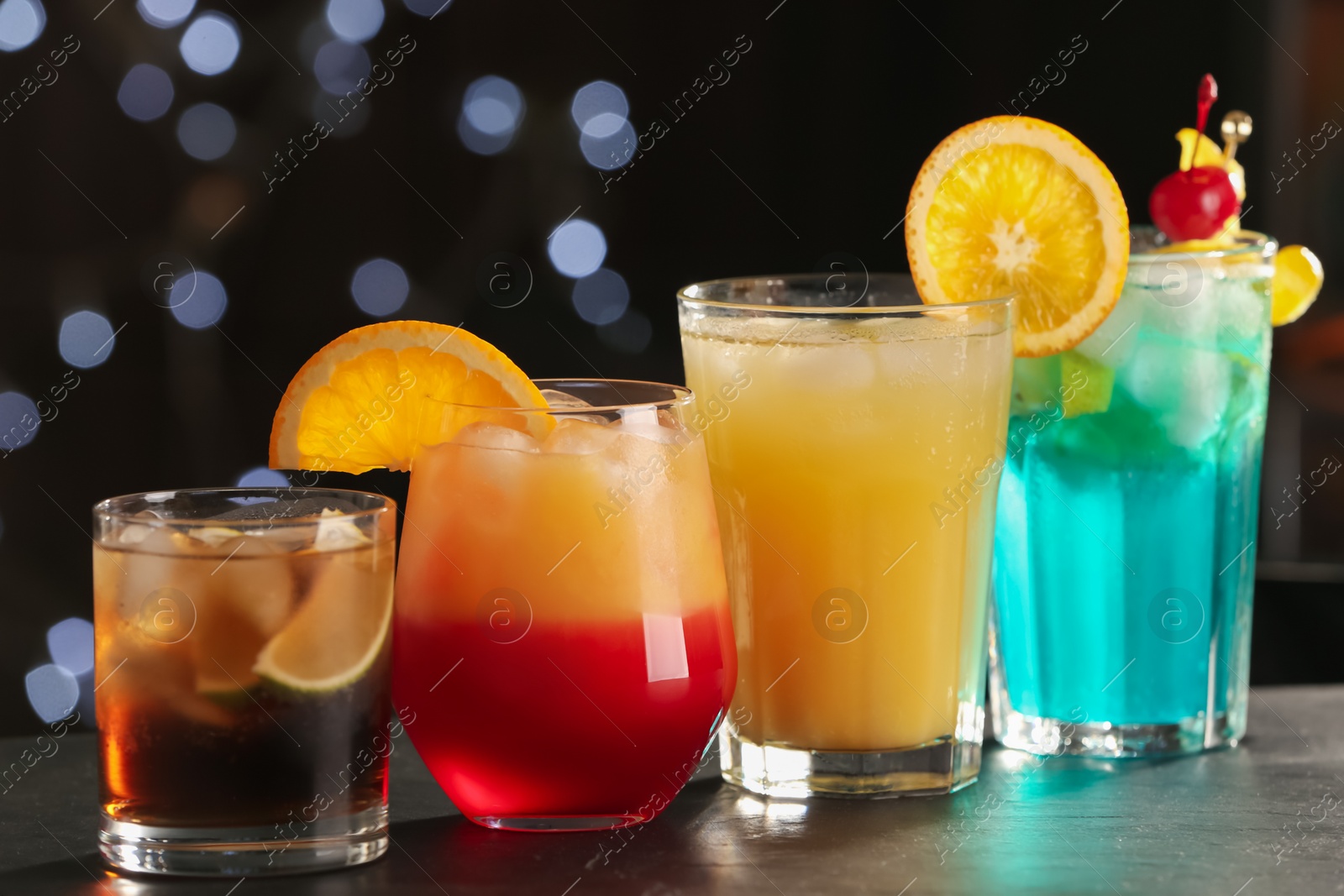 Photo of Different delicious cocktails on counter in bar